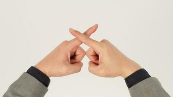 Forbidden or rejection hand sign in a gray suit on white background. Studio shooting. photo