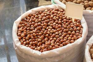 Hazelnuts in a big bag. Hazelnut background, healthy food photo