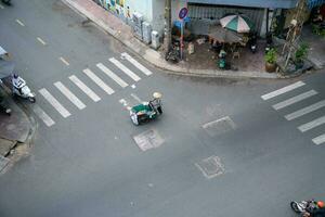 Ho Chi Minh, Viet Nam - 22 April 2023 High view of street in district 5, Ho Chi Minh city, Vietnam. Citizen transport by motorcycles photo