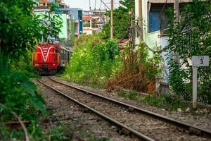 Incredible view of train passing through a narrow street, the Hanoi Old Quarter. Stock photo