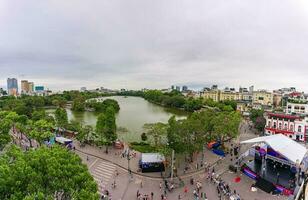 Hanoi, Viet Nam - 13 May 2023 Aerial view of Hoan Kiem Lake  Ho Guom or Sword lake in the center of Hanoi in the fog in the morning. Hoan Kiem Lake is a famous tourist place in Hanoi. Travel concept photo