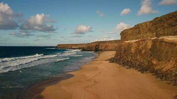 A wild beach with a rocky shore, big waves on the ocean. video