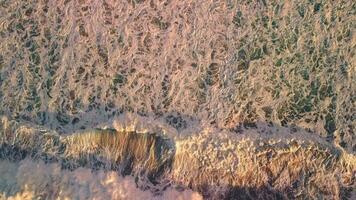 A top view of the large peals of the waves and the resulting sea foam. video