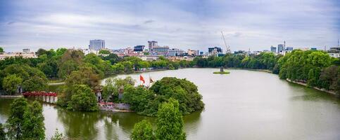 Hanoi, Viet Nam - 13 May 2023 Aerial view of Hoan Kiem Lake  Ho Guom or Sword lake in the center of Hanoi in the fog in the morning. Hoan Kiem Lake is a famous tourist place in Hanoi. Travel concept photo