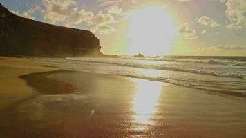 Flying low over the water, sunset, sea foam and the rays of the bright sun. video