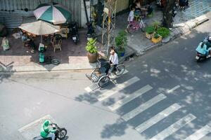 Ho Chi Minh, Viet Nam - 22 April 2023 High view of street in district 5, Ho Chi Minh city, Vietnam. Citizen transport by motorcycles photo