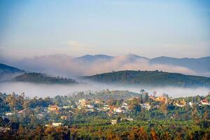 Mountains during dawn. Beautiful natural landscape in the summer time with fog photo