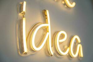 idea, LED neon light on wall ,Business background design with long shadow text photo