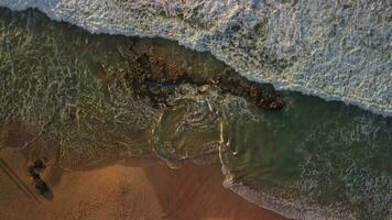 Top view of large waves with sea foam, sunset. video