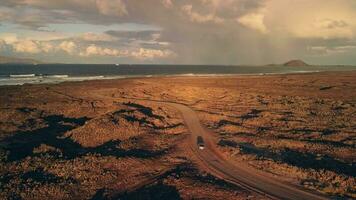 The road is along the sea, the car is driving along the road. video