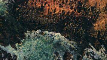 Top view of the road running along the rocky high shore of the ocean. video