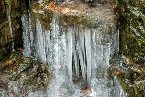 Icicles on a rock wall photo
