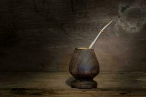 yerbamate and light bulb on rustic wooden background photo