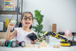 STEM education concept. Asian students learn at home by coding robot arms in STEM, mathematics engineering science technology computer code in robotics for kids' concepts photo