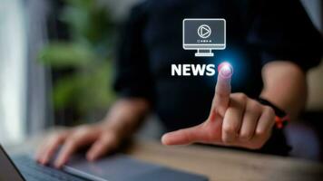 Women hand presses the play button with the news text. Broadcasting, publishing, or watching the latest news concept. photo