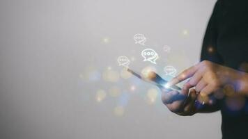 Live chat chatting and social network concepts, Close-up hands using mobile smartphone with chat box icons photo