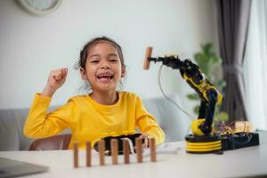 STEM education concept. Asian students learn at home by coding robot arms in STEM, mathematics engineering science technology computer code in robotics for kids' concepts. photo