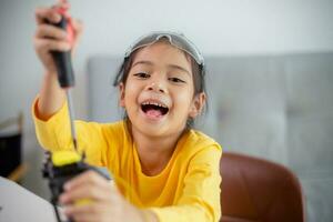 STEM education concept. Asian students learn at home by coding robot arms in STEM, mathematics engineering science technology computer code in robotics for kids' concepts. photo