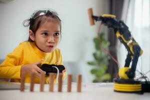 STEM education concept. Asian students learn at home by coding robot arms in STEM, mathematics engineering science technology computer code in robotics for kids' concepts. photo
