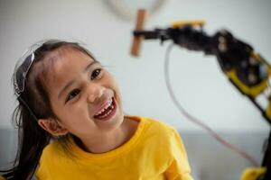 STEM education concept. Asian students learn at home by coding robot arms in STEM, mathematics engineering science technology computer code in robotics for kids' concepts. photo