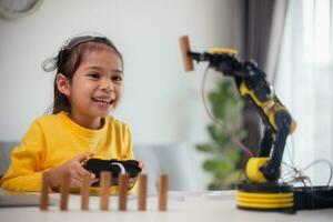 STEM education concept. Asian students learn at home by coding robot arms in STEM, mathematics engineering science technology computer code in robotics for kids' concepts. photo