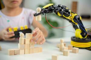 STEM education concept. Asian students learn at home by coding robot arms in STEM, mathematics engineering science technology computer code in robotics for kids' concepts photo
