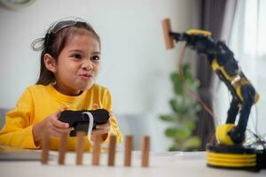 STEM education concept. Asian students learn at home by coding robot arms in STEM, mathematics engineering science technology computer code in robotics for kids' concepts. photo