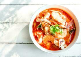 Famous food in Thailand. Tom Yum Kung on table with copy space photo