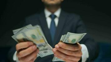 Formally dressed man counting US Dollar bills, close-up. video