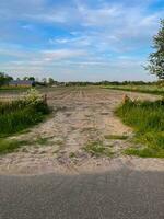 Experience the rustic charm of a plowed field merging with sandy textures, revealing a captivating landscape where nature's raw beauty unfolds photo