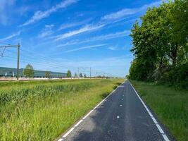 Pedal alongside the rhythmic flow of trains on a bike lane parallel to the tracks, where adventure and urban vibes converge in a unique and dynamic journey photo