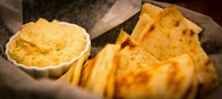 Basket of hummus and pita photo