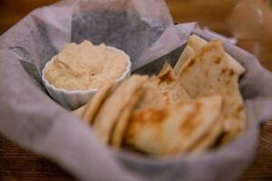 Basket of hummus and pita photo