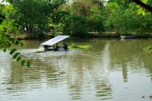 A far view of Water turbine for increasing oxygen in the water pool aquaculture. It spins by solar energy - electric sunlight automatic - clean energy technology industry to save the world photo