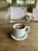 Hot coffee cup on wooden table photo