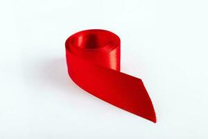 Red silk ribbon for wrapping gifts on white background. photo