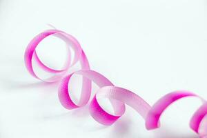 Pink ribbon for wrapping gifts on white background. photo