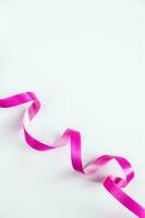 Pink ribbon for wrapping gifts on white background. photo