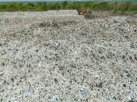 Aerial view landfill garbage waste huge dump environmental pollution problem, Top view on plastic and other industrial waste ecological disaster from above with garbage sorting garbage disposal photo