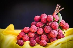 fresh ripe lychee fruit tropical fruit peeled lychees slice in Thailand, lychees on table and black background photo