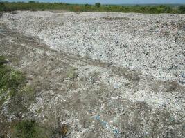 Top view on plastic and other industrial waste ecological disaster from above with garbage sorting garbage disposal , Aerial view landfill garbage waste huge dump environmental pollution problem photo