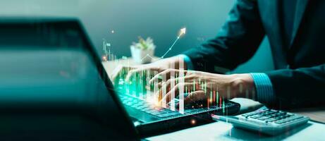 Businessman using laptop and analyzing economic growth, financial graph and business investment. planning strategy, stock market statistics, stock market trends, technical analysis strategy, value photo
