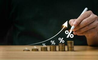 interest rates and dividends, investment returns, income, retirement Compensation fund, investment, dividend tax. pile of coins and upward direction percentage symbol. saving money for investment photo