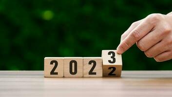 2023 business ideas and market trends concept, goal, action plan, strategy, new year business vision. hand holding goal and cubes with text 2023. Development to success and motivation. target group photo