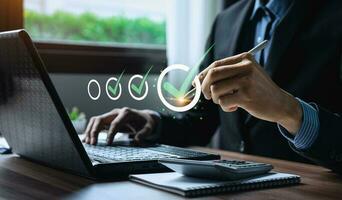 Business performance checklist, businessman using laptop doing online checklist survey, Check marks on checklist and Filling online form or answering questions. evaluation, online survey, online exam. photo