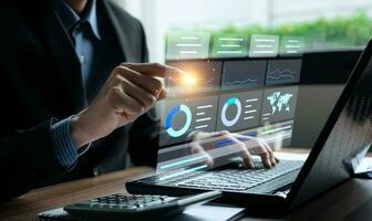 Businessman analyzing business enterprise data management, Business analytics with charts, metrics and KPIs to performance organization. Corporate strategy for finance, operations, sales, marketing photo