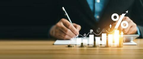 interest rates and dividends, investment returns, income, retirement Compensation fund, investment, dividend tax. pile of coins and upward direction percentage symbol. saving money for investment photo