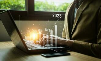 stock market trends for 2023, Businessman calculating financial data for long term investments. Analytical businessman planning business growth 2023, strategy digital marketing, profit income, economy photo