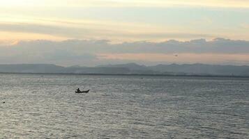 Fisherman Silhouette on His Boat photo