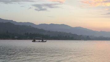 Fisherman Silhouette on His Boat photo